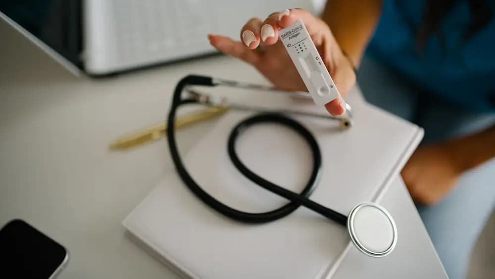 A stethoscope and medical supplies on a clinic desk