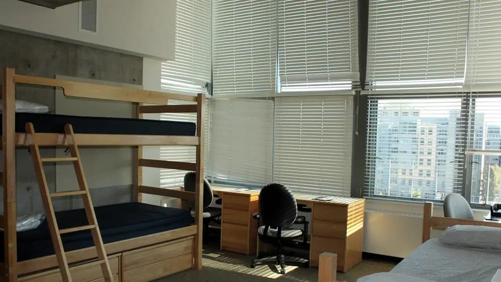 A made-up dormitory room in a boarding house