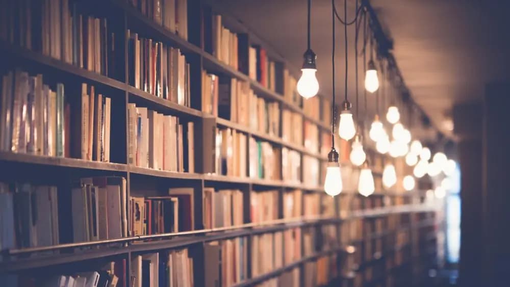 The reading room of a library, shelves either side