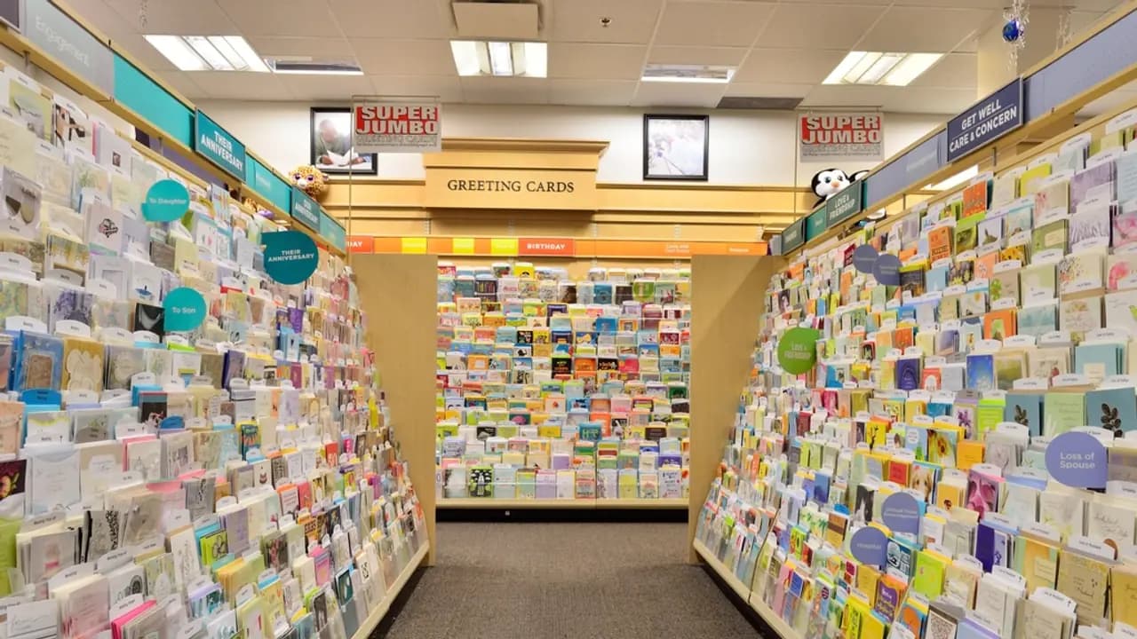 Shelves of goods down a shop aisle