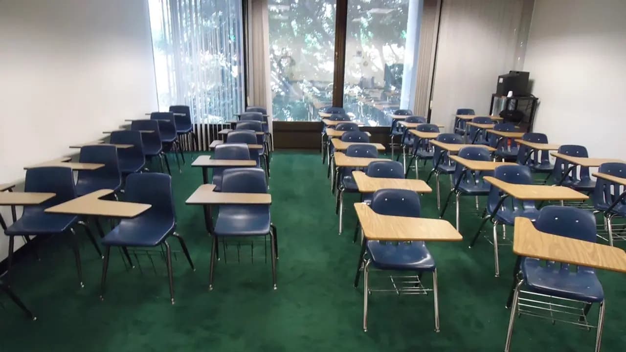 An empty classroom of desks and chairs
