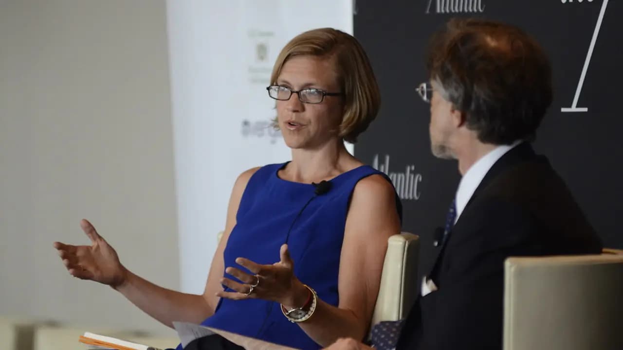 Two people talking across a table in an interview