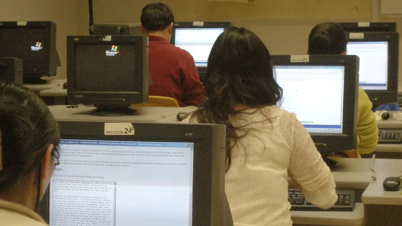 Candidates at screens in a school computer room