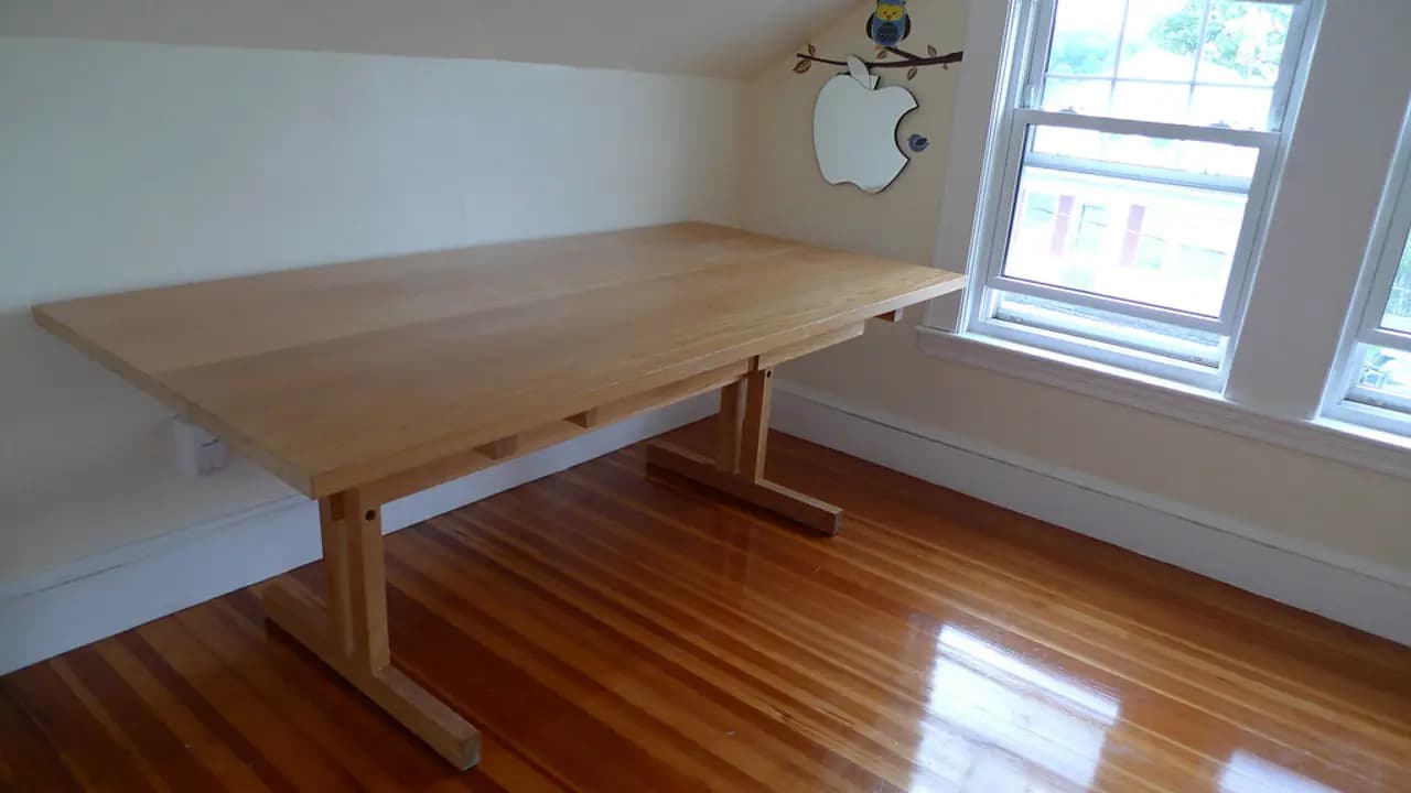 An empty desk by a window in a quiet room