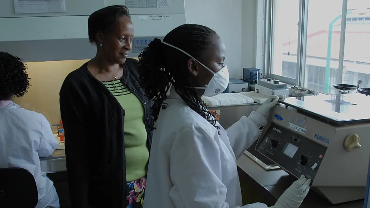 Secondary pupils in lab coats working with equipment